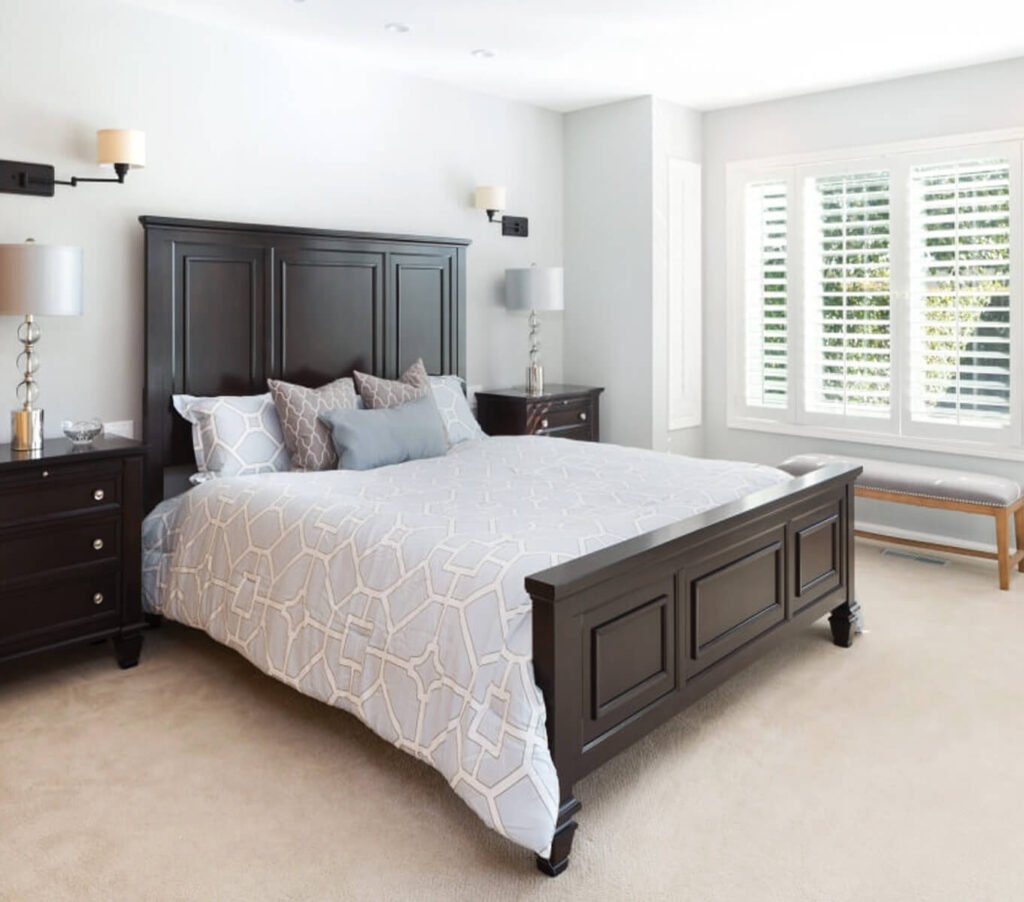 Elegant bedroom with dark wood furniture and light gray accents