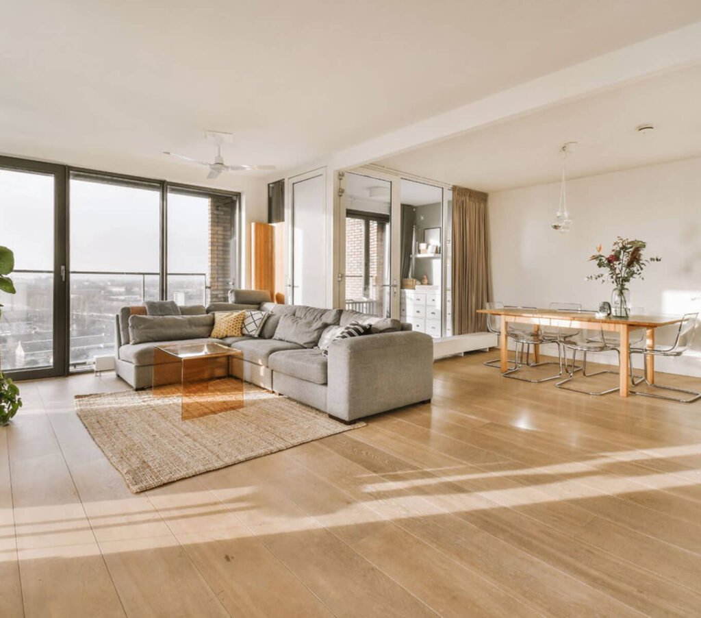 Modern living room and dining area with large windows and natural light