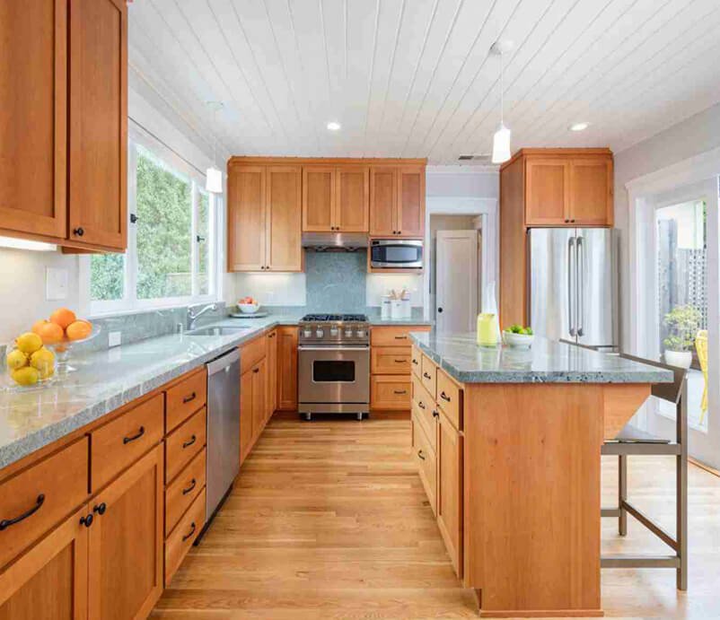 Spacious kitchen with wooden cabinets, island, and stainless appliances