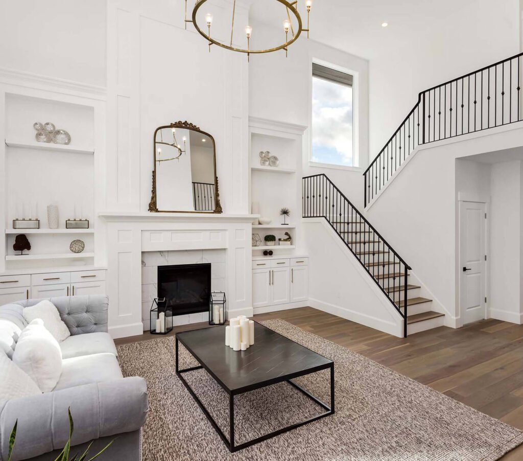 Spacious living room with fireplace, chandelier, and staircase
