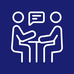 Icon of two people having a conversation at a table